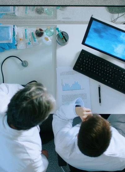 Top view of two doctors discussing in front of a computer